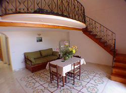 Vacation Lodging Positano: The living-room with the mezzanine floor of Ludovica Type C Vacation Lodging in Positano
