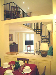 Rome Apartment Rental: Living and dining-room with spiral staircase of Tritone Type D Rental Apartment in Rome