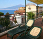 Apartment in Sorrento: Terrace od Rosy apartment with table and chairs and Vesuvius in the background